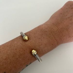 David Yurman sterling silver and 18 karat yellow gold cable bracelet.
